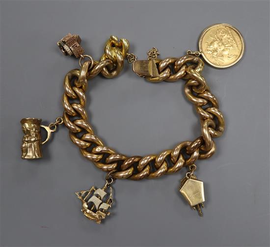 A yellow metal curb-link bracelet (tests as 14ct), hung with a 1905 half sovereign and four various charms (three extra links)